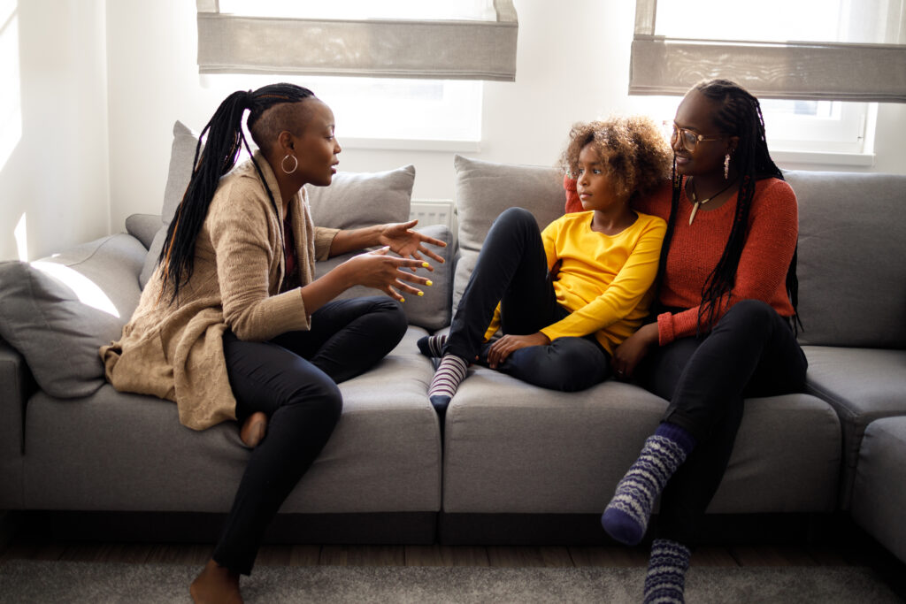 Three women communicating on the couch